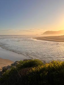 a beach with a body of water and the ocean at Sand Castle in Sedgefield +16 photos