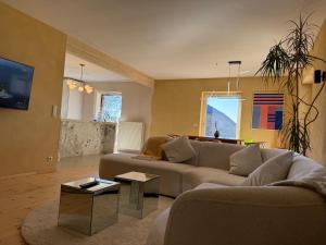 a living room with a couch and a table at Rainbow Bungalow in Butgenbach