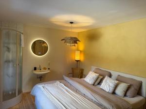 a bedroom with a large bed and a sink at Rainbow Bungalow in Butgenbach