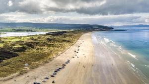 an aerial view of a beach with cars parked at Anchorage Inn in Portstewart