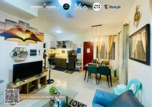a living room with a couch and a dining room at CENIA UNIT Staycation House in Dauis