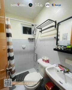 a small bathroom with a toilet and a sink at CENIA UNIT Staycation House in Dauis