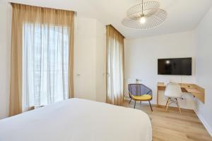 a bedroom with a bed and a desk and a chair at MAISON SAINT CHARLES - ASSOCIATION HABITAT et HUMANISME ILE DE FRANCE in Paris +33 photos