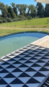 a swimming pool with a black and white checkered floor at Casa Cosmos in Colonia Ayui