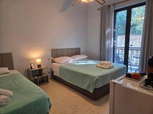 a bedroom with two beds and a window at Elea rooms 7 in Elia Laconias