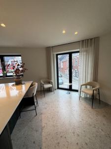 a room with chairs and a table and a large window at The Corner-LISETTE in Oedelem +9 photos