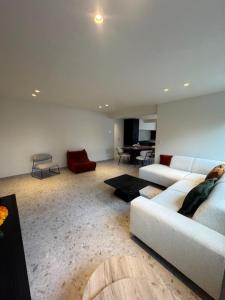 a living room with a white couch and a table at The Corner-LISETTE in Oedelem