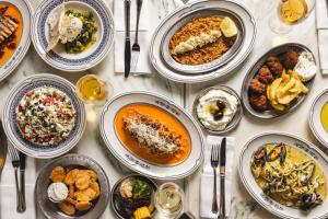 a table with many plates of food on it at Ergon House Ermou in Athens