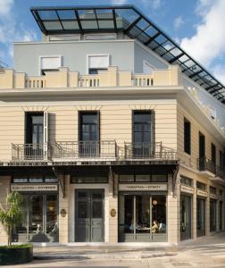 an apartment building with a balcony on top of it at Ergon House Ermou in Athens