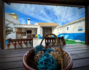 a basket of blue rope sitting on a table in front of a house at Alojamiento Rural La Tinaja in Ayna