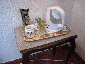 a table with a tea kettle and cups on it at Apartment Yasica 2 in Izačić