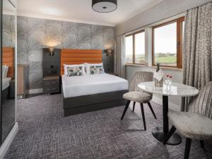 a hotel room with a bed and a table at Diamond Coast Hotel in Enniscrone +28 photos