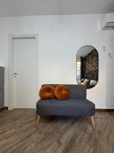 a blue couch with two pillows in a room with a mirror at B&B La Fenice Suite in Salerno