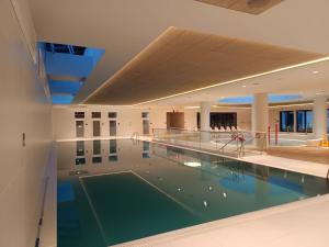 a large swimming pool in a building with a swimming pool at PINEA 2 BEDROOM APARTMENT WITH Sea VIEW in Pobierowo
