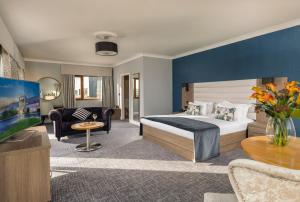 a hotel room with a bed and a living room at Diamond Coast Hotel in Enniscrone