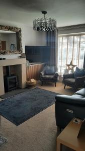 a living room with a couch and a fireplace at Coastal Rest in Beadnell