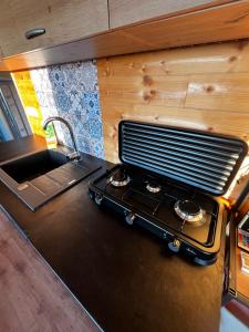 a kitchen with a stove and a sink at Mája u lomu in Stachlovice