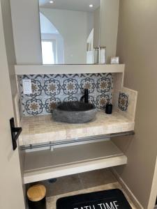 a sink in a bathroom with a mirror at Douce escale in Le Crotoy +18 photos