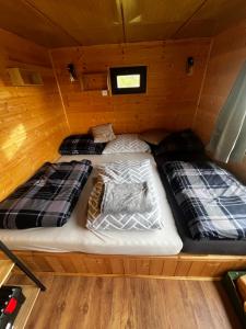 two beds in the middle of a cabin at Mája u lomu in Stachlovice +4 photos