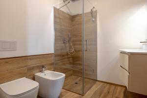 a bathroom with a shower and a toilet and a sink at Ca da Smarè - Where Time stands Still in Someraro +21 photos