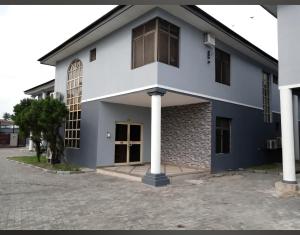 a house with a blue and white facade at Transit Care Hotel in Port Harcourt