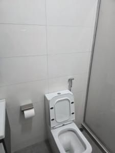 a bathroom with a toilet in a stall at Transit Care Hotel in Port Harcourt +7 photos