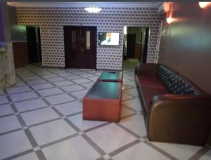 a lobby with a couch and a table in a room at Transit Care Hotel in Port Harcourt