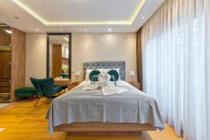 a bedroom with a bed with two white towels on it at Vila Pino Silvestre in Zlatibor