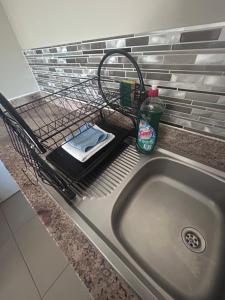 a dish drying rack with a sink in a kitchen at Modern , Spotless Townhouse in Quiet Estate - Pietermaritzburg in Pietermaritzburg +34 photos