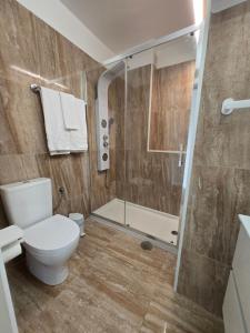 a bathroom with a toilet and a shower at Mãe Maria House Guest House in Vila Chã +51 photos
