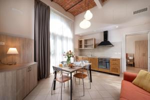 a kitchen with a table and chairs in a room at Hotel Palazzo Borghini - Gruppo Estella Hotels in Florence