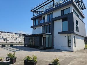 a large white building with a large garage at Mysig Villa in Ch'eng-kung-li