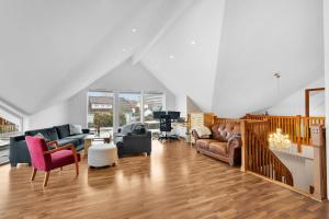 a large living room with couches and chairs at Villa Stavanger 5 bedrooms 5 bathrooms and large swimming pool in Stavanger