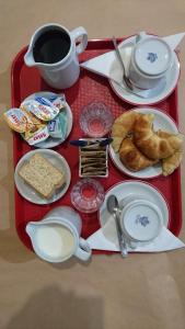 a red tray with breakfast foods and a cup of coffee at Hotel KEY´S in Buenos Aires
