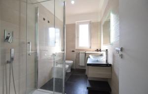 a bathroom with a shower and a toilet and a sink at Oltremare - casa vacanze Agropoli appartamento rooms in Agropoli +6 photos