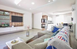 a living room with a couch and a table and a kitchen at Oltremare - casa vacanze Agropoli appartamento rooms in Agropoli
