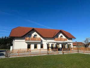 a large white house with a brown roof at Anivina - B&B in Ivanjkovci