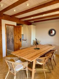 a dining room with a wooden table and chairs at Dom na Kaszubach, Żuromino 2 0 in Żuromino