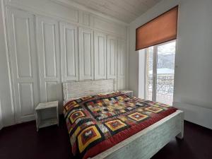 a bedroom with a bed with a quilt on it at Authentic house with a huge garden in Utsera