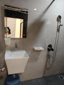 a bathroom with a sink and a shower with a mirror at Ganesh Nilayam in Hyderabad +10 photos