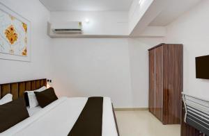 a bedroom with a bed and a television in it at Hotel Vijai Square in Prayagraj