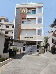 a building with a clock on the side of it at Ganesh Nilayam in Hyderabad