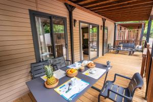 a table and chairs on the porch of a house at Club del Sole Due Laghi Levico Family Collection in Levico Terme