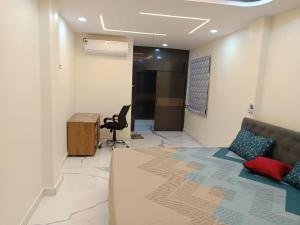 a living room with a couch and a desk at Ganesh Nilayam in Hyderabad