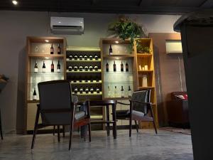 a table and chairs in a room with bottles of wine at Museum Hotel in George Town +22 photos