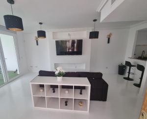 a living room with a couch and a table at Hidden Gem between Waves & Mountains in Lo Gea