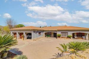 a large white house with a large driveway at The Adress beautiful in Midrand