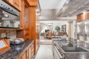 a kitchen with wooden cabinets and a counter top at The Adress beautiful in Midrand