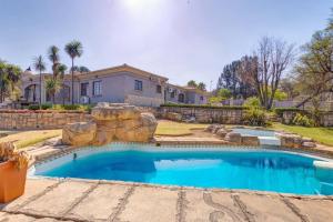 a swimming pool in front of a house at The Adress beautiful in Midrand