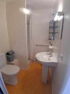 a white bathroom with a toilet and a sink at chambre dhote condat sur ganaveix in Condat-sur-Ganaveix